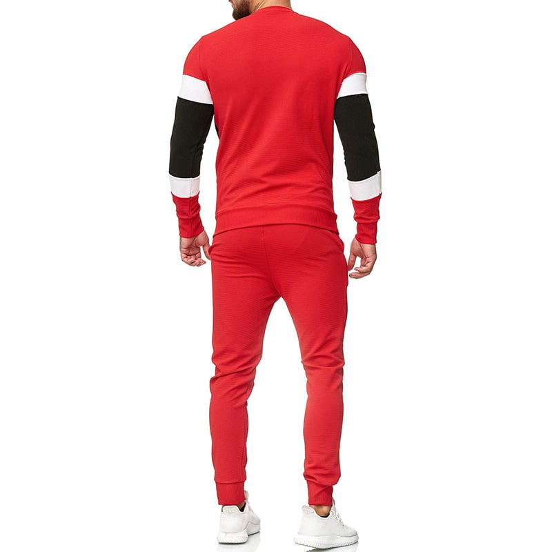 Tuta sportiva uomo rossa, maniche lunghe con dettagli neri e bianchi, vista posteriore. Abbigliamento casual, moda maschile, stile moderno.