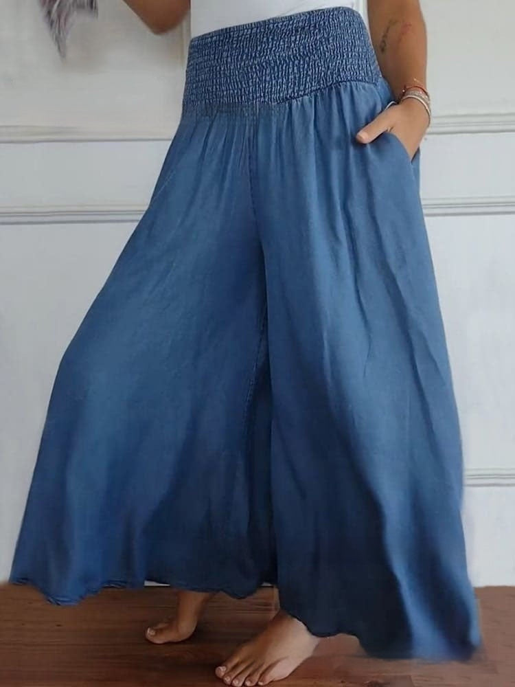 Pantaloni palazzo in denim blu, vita alta elasticizzata, stile casual estivo, moda donna, comodi e ampi, perfetti per look rilassati.