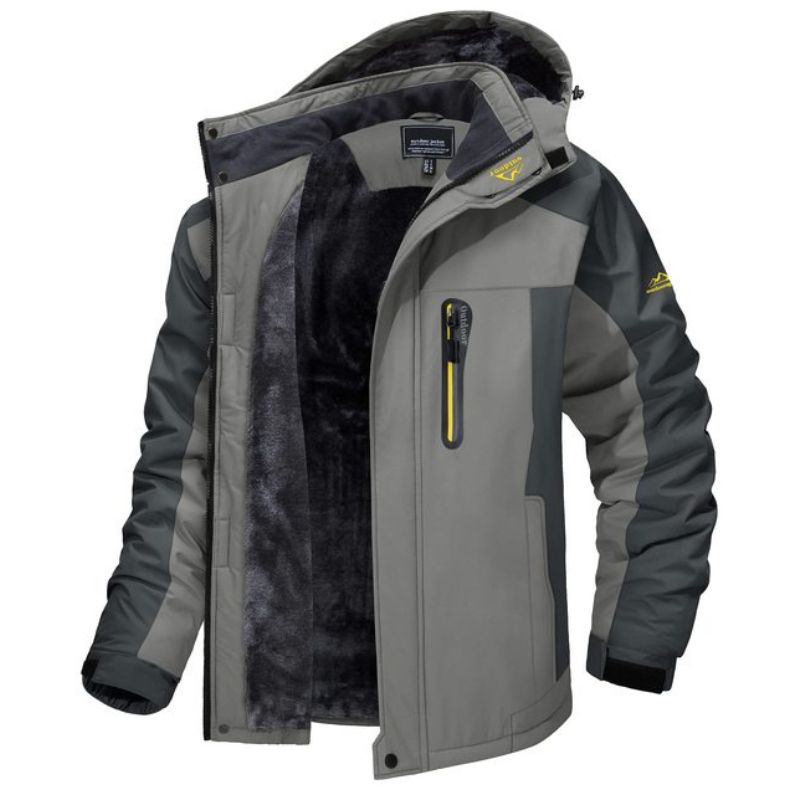 Giacca invernale da uomo grigia con cappuccio, interno in pelliccia sintetica, tasca con zip, design sportivo, ideale per escursioni e attività outdoor.
