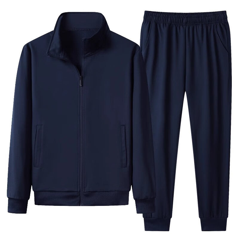 Tuta sportiva blu scuro, composta da giacca con zip e pantaloni con elastico in vita. Abbigliamento casual e confortevole per attività sportive.