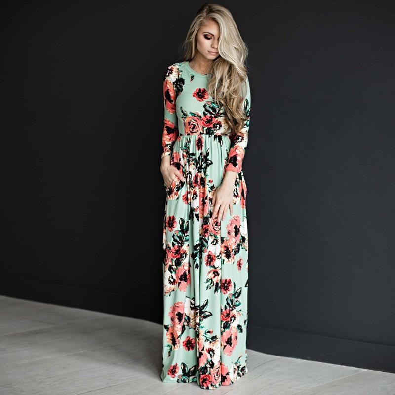Abito lungo floreale verde menta con maniche lunghe, indossato da una donna bionda. Moda elegante, abbigliamento femminile, tendenza 2023.