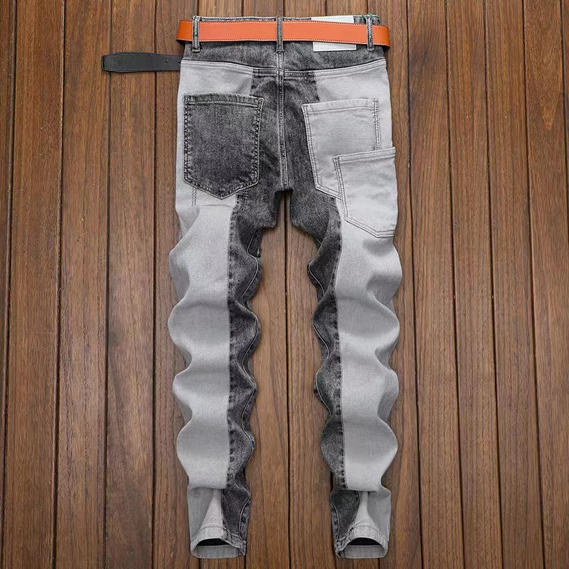 Jeans slim fit grigi e neri da uomo, design moderno con tasche posteriori, su pavimento in legno. Moda maschile, abbigliamento casual.
