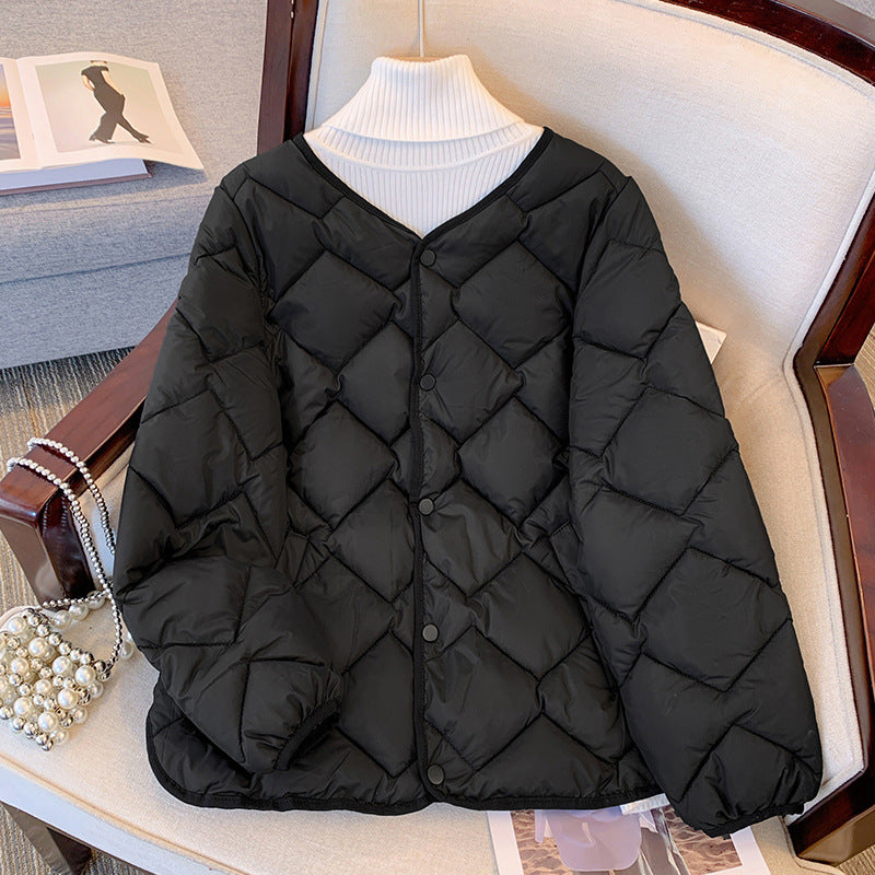 Giacca trapuntata nera su sedia, design a rombi, collo a V, perfetta per moda invernale. Elegante e calda, ideale per look casual e chic.