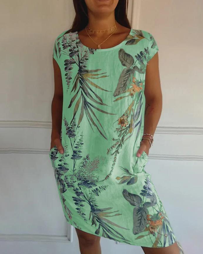 Abito estivo verde con stampa floreale tropicale, maniche corte, tasche laterali. Perfetto per moda donna, look casual e fresco.
