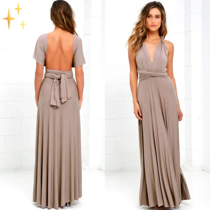 Abito lungo elegante beige con scollo a V e schiena scoperta, cintura annodata in vita, tessuto fluido, perfetto per cerimonie e serate glamour.