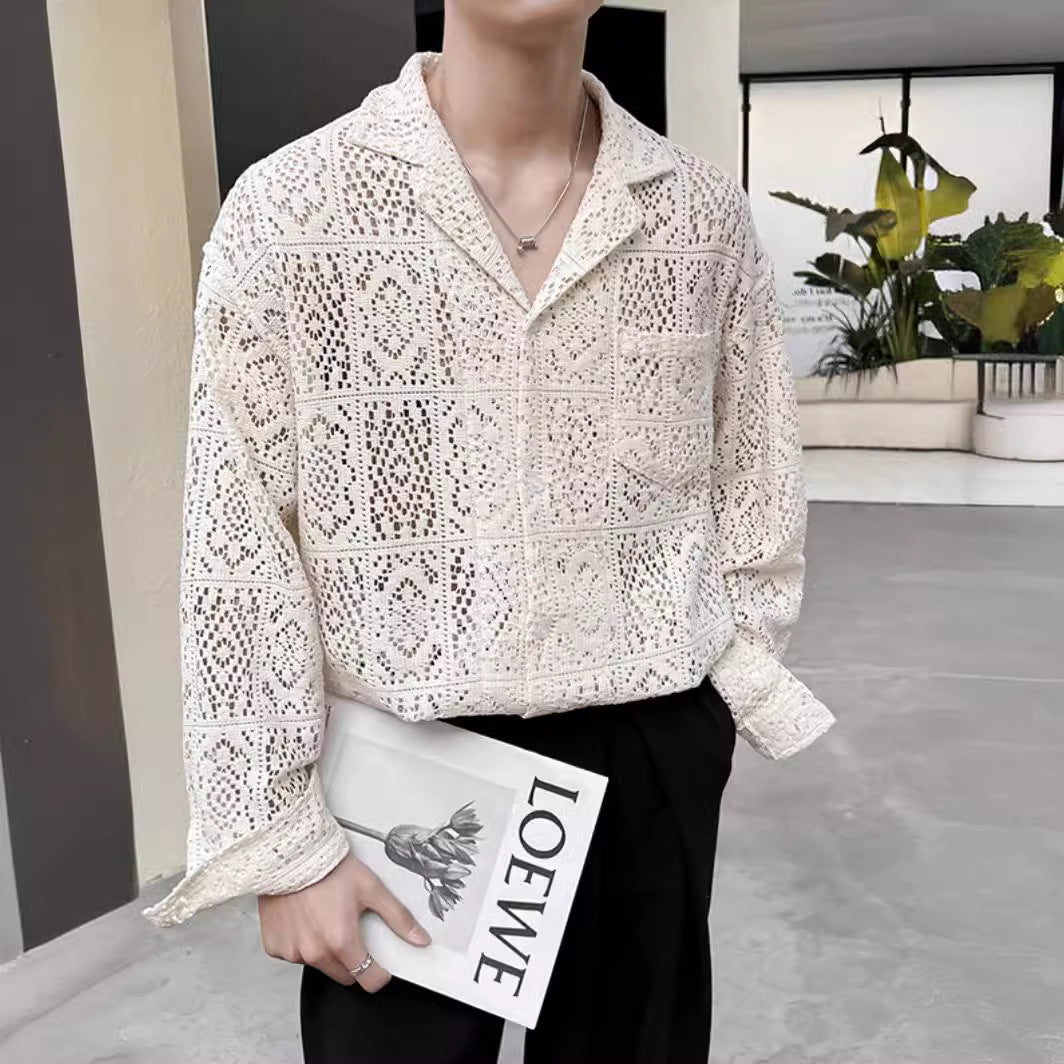 Camicia in pizzo bianco elegante, uomo con libro "Loewe" in mano, moda contemporanea, outfit casual-chic, piante decorative sullo sfondo.