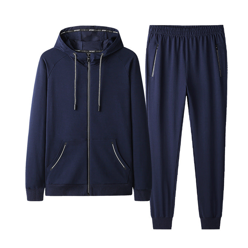 Tuta sportiva blu scuro da uomo, con felpa con cappuccio e pantaloni, cerniere nere, tasche laterali, ideale per allenamento e tempo libero.