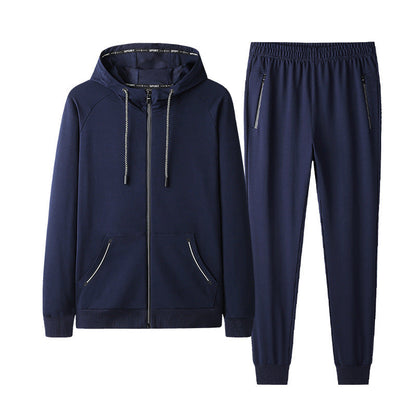 Tuta sportiva blu scuro da uomo, con felpa con cappuccio e pantaloni, cerniere nere, tasche laterali, ideale per allenamento e tempo libero.