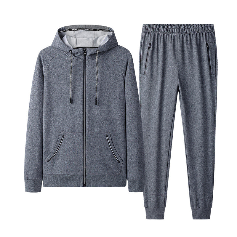 Tuta sportiva grigia da uomo, composta da felpa con cappuccio e pantaloni, ideale per allenamento e tempo libero. Design moderno e confortevole.