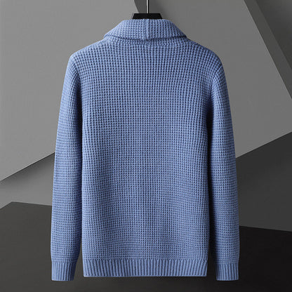 Maglione blu in lana lavorata a maglia, design elegante e moderno, sfondo geometrico grigio. Moda uomo, abbigliamento invernale di tendenza.