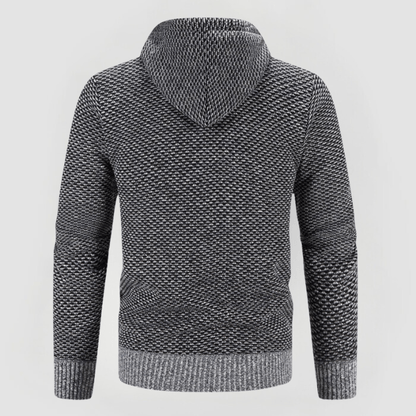 Felpa con cappuccio grigia a maglia, design a trama intrecciata, maniche lunghe, ideale per moda casual e comfort invernale.