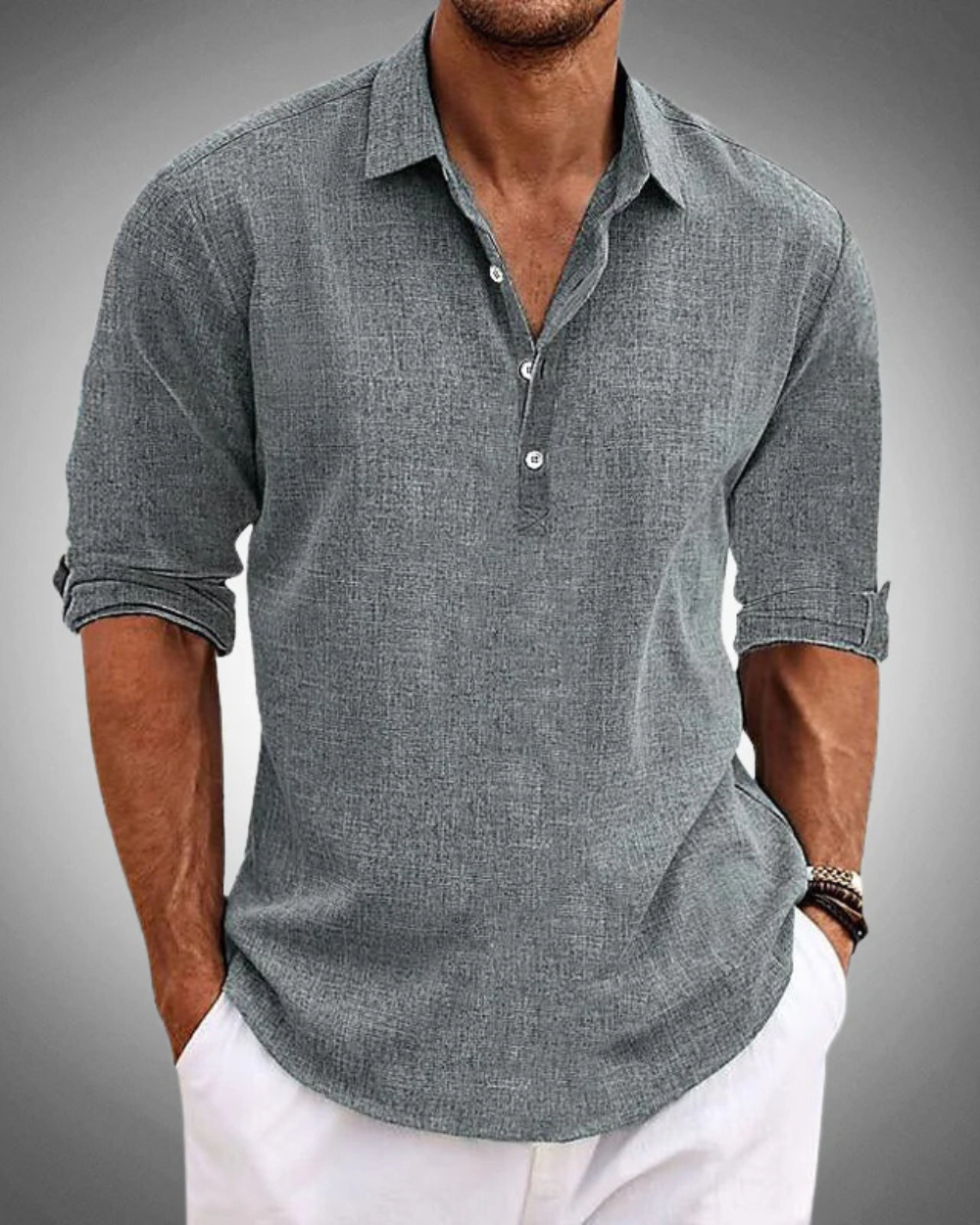 Camicia uomo grigia a maniche lunghe, tessuto leggero, colletto classico, abbinata a pantaloni bianchi. Moda casual elegante maschile.