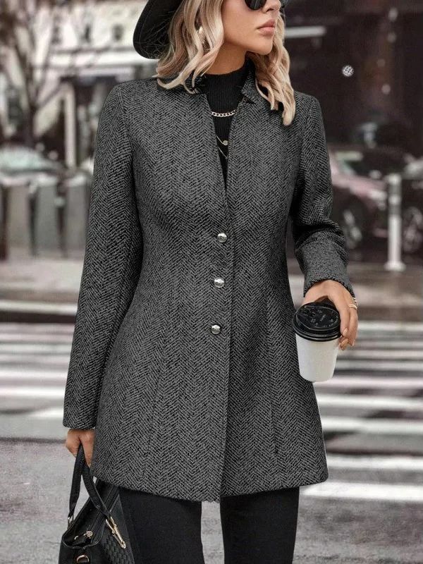 Donna con cappotto grigio elegante, cappello nero e occhiali da sole, tiene caffè da asporto e borsa. Moda autunnale in città.