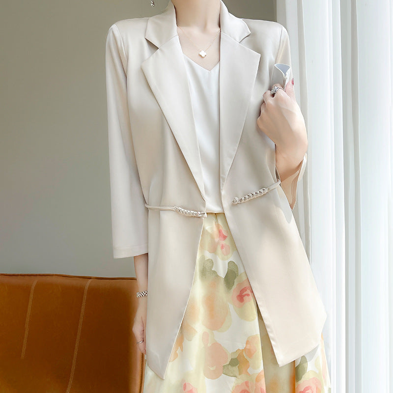 Blazer beige elegante da donna su camicetta bianca, abbinato a gonna floreale. Moda femminile, abbigliamento primaverile, stile casual chic.