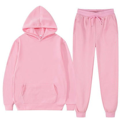 Tuta sportiva rosa in cotone, composta da felpa con cappuccio e pantaloni con coulisse. Abbigliamento casual unisex, moda comoda e trendy.
