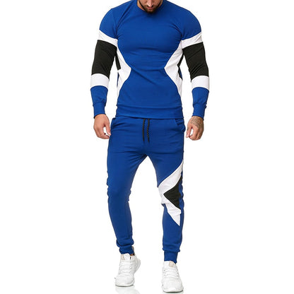 Tuta sportiva uomo blu con dettagli bianchi e neri, maniche lunghe, pantaloni jogger, scarpe da ginnastica bianche. Moda fitness maschile.