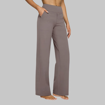 Pantaloni yoga donna grigi, a vita alta, con tasche laterali, comodi e larghi, ideali per fitness e relax. Abbigliamento sportivo femminile.
