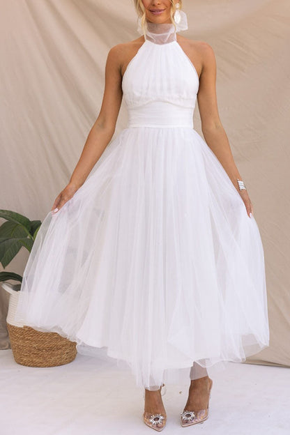 Abito da sposa bianco in tulle, senza maniche, con scollo all'americana. Elegante e moderno, perfetto per matrimoni estivi.