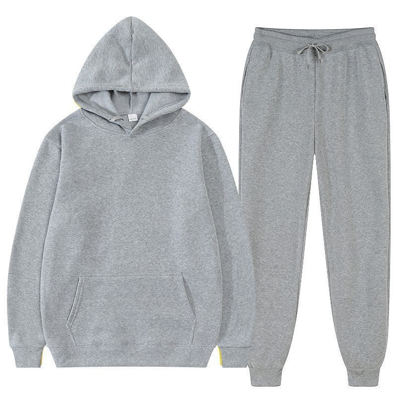 Felpa con cappuccio e pantaloni grigi, abbigliamento sportivo unisex, comodo e casual, ideale per palestra e tempo libero.