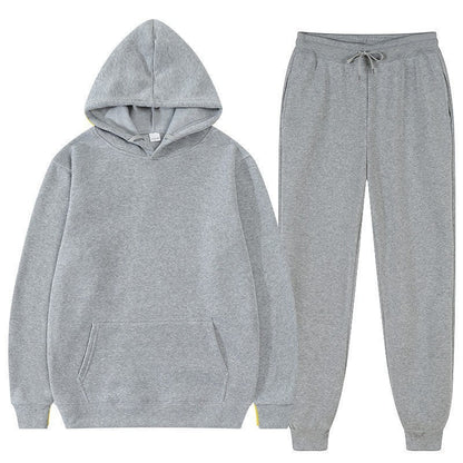 Felpa con cappuccio e pantaloni grigi, abbigliamento sportivo unisex, comodo e casual, ideale per palestra e tempo libero.