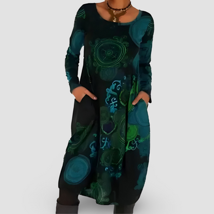 Abito lungo donna nero con motivi astratti verdi e blu, maniche lunghe, tasche laterali, stile casual elegante. Moda femminile autunno inverno.