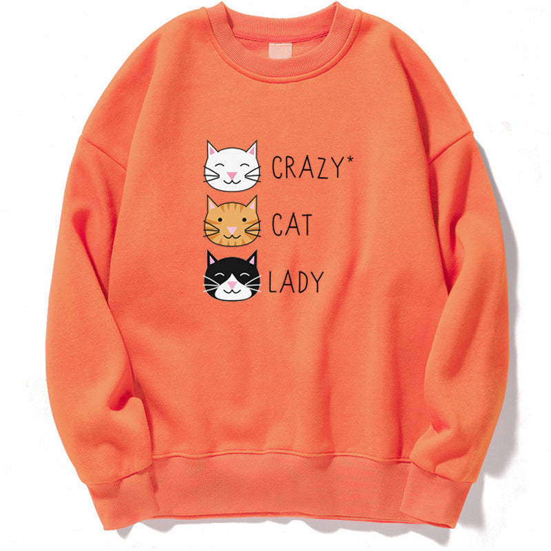 Felpa arancione con stampa di tre gatti sorridenti e la scritta "Crazy Cat Lady". Abbigliamento casual, moda felpe, amanti dei gatti.