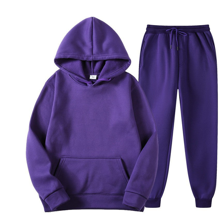 Tuta sportiva viola unisex, composta da felpa con cappuccio e pantaloni, ideale per abbigliamento casual e sportivo.