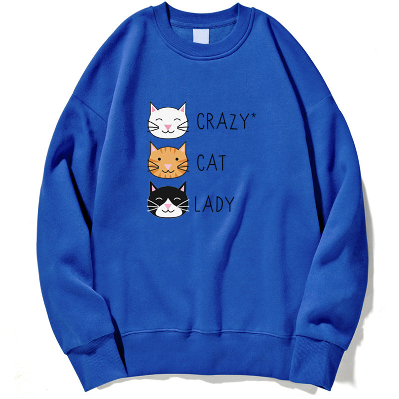 Felpa blu con stampa di tre gatti sorridenti e la scritta "Crazy Cat Lady". Abbigliamento casual, moda felpe donna, stile gatto.