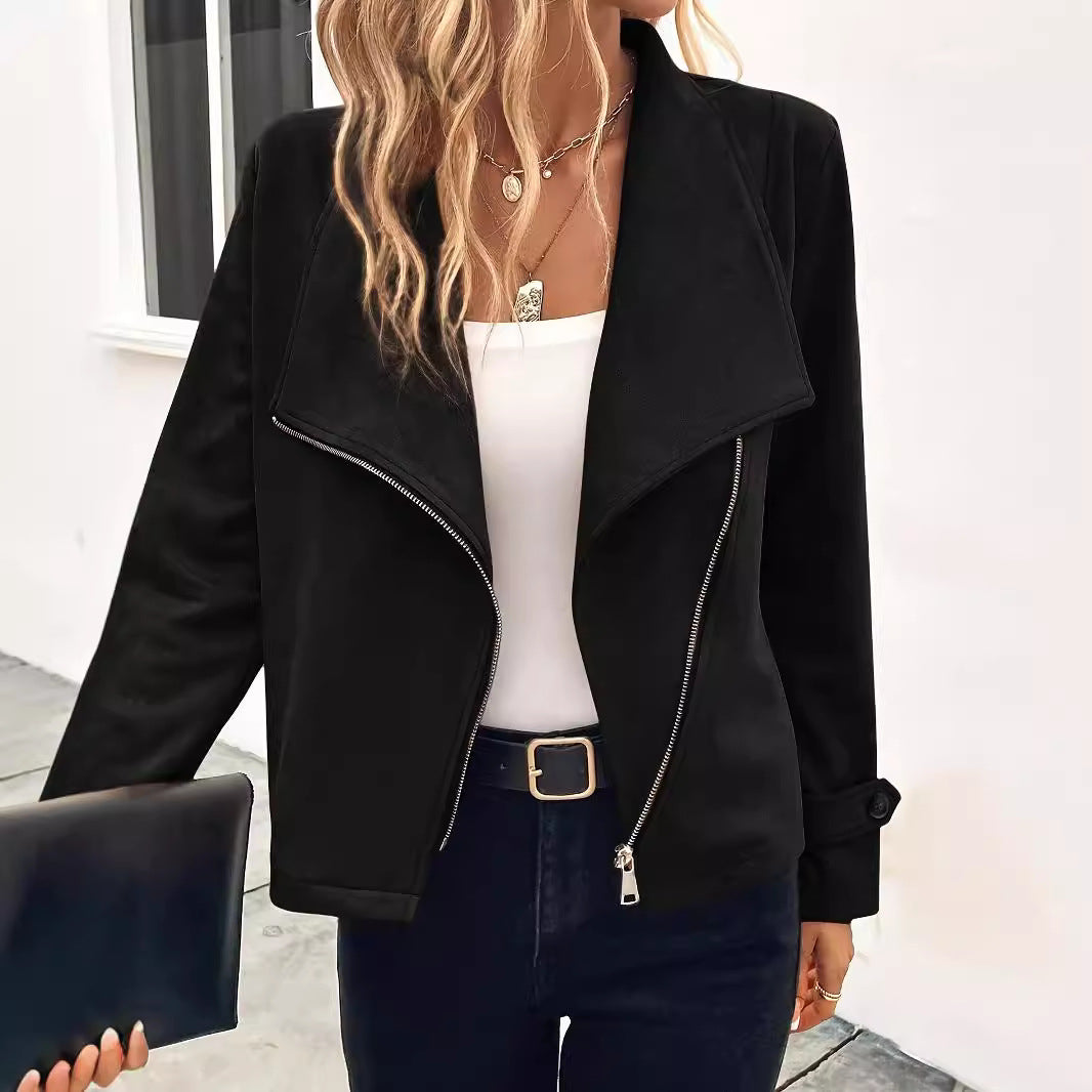 Donna con giacca nera elegante, top bianco e jeans scuri, tiene una pochette. Moda autunnale, stile casual chic, outfit femminile moderno.