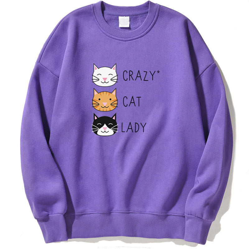 Felpa viola con stampa di tre gatti sorridenti e la scritta "Crazy Cat Lady". Abbigliamento casual, moda felpe donna, stile gatto.