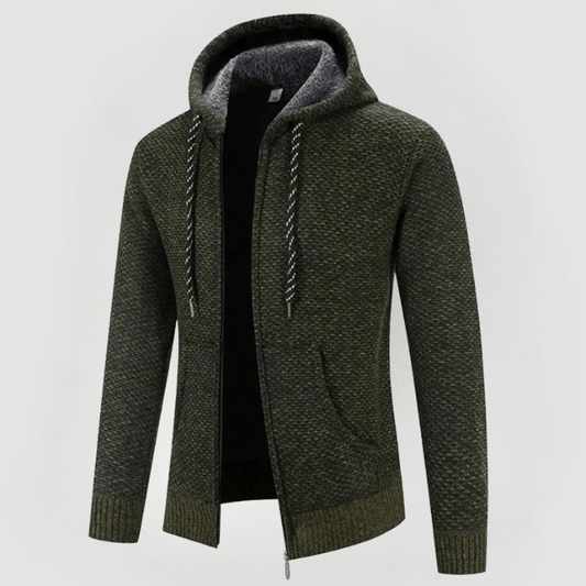 Felpa con cappuccio verde oliva, tessuto a maglia, zip frontale, tasche laterali, interno foderato in pile grigio, cordini bianchi e neri.