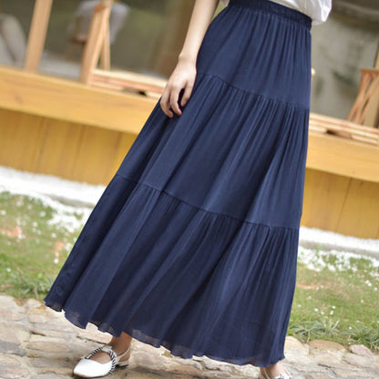 Gonna lunga blu a balze indossata da una donna, con scarpe bianche e nere. Moda estiva femminile, abbigliamento casual elegante.