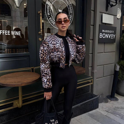 Donna con giacca leopardata e occhiali da sole davanti a caffetteria Marriott Bonvoy. Moda urbana, stile elegante, abbigliamento trendy.