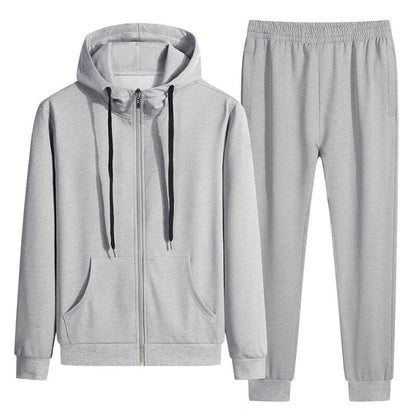Tuta sportiva grigia unisex, composta da felpa con cappuccio e pantaloni. Abbigliamento casual, comodo e moderno per attività sportive e tempo libero.