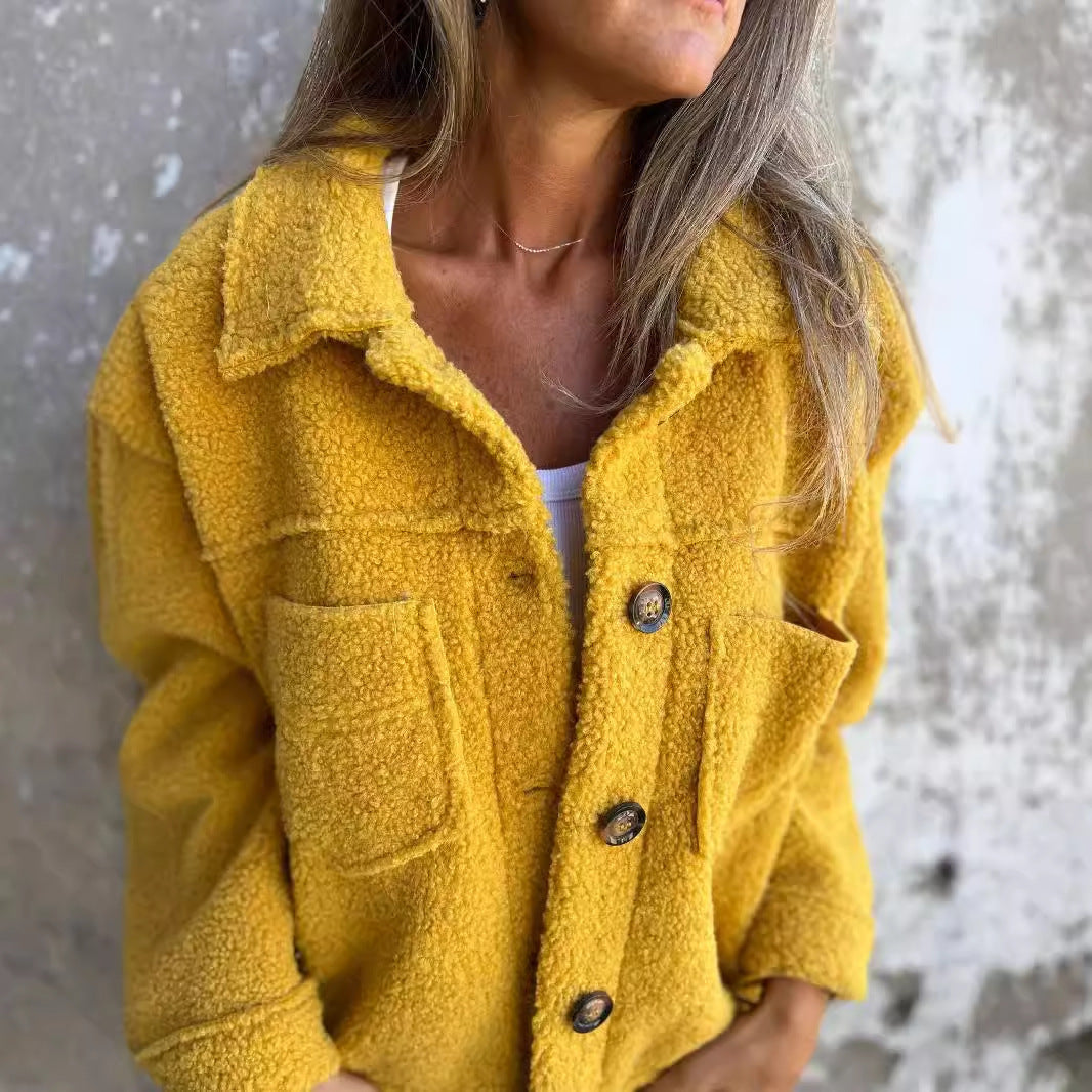 Giacca in pile giallo senape con bottoni grandi, indossata da una donna. Moda autunnale, abbigliamento casual, tendenza tessuti morbidi.