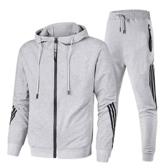 Tuta sportiva grigia con cappuccio, zip frontale e pantaloni abbinati. Design con strisce nere laterali. Abbigliamento casual e comodo.