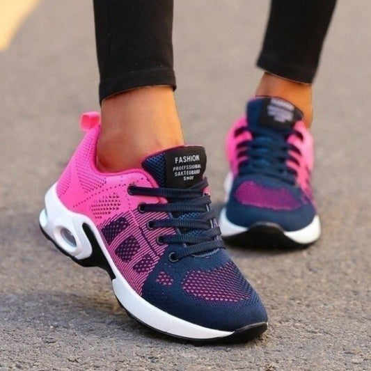 Scarpe da ginnastica donna, design moderno, colori rosa e blu, suola ammortizzata, ideali per corsa e sport, moda casual, strada asfaltata.