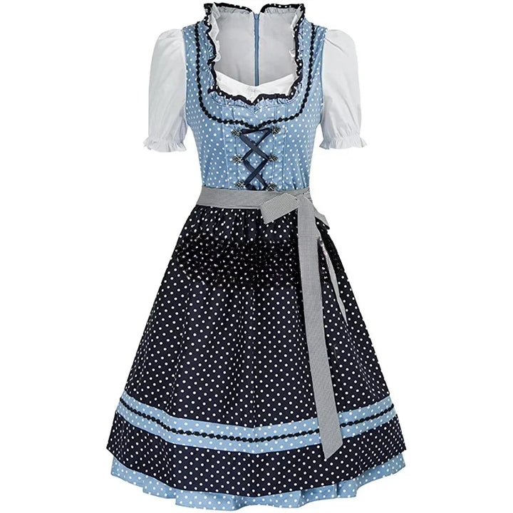 Abito tradizionale bavarese dirndl blu e nero a pois, con corpetto incrociato e grembiule grigio. Perfetto per Oktoberfest e feste a tema.