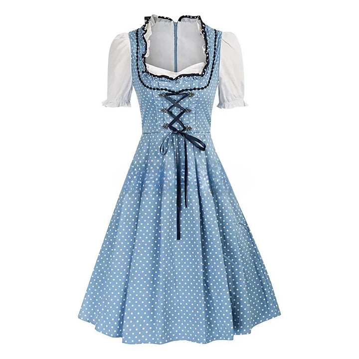 Abito tradizionale bavarese blu a pois bianchi, con corpetto a lacci e maniche corte bianche. Perfetto per Oktoberfest e feste a tema.