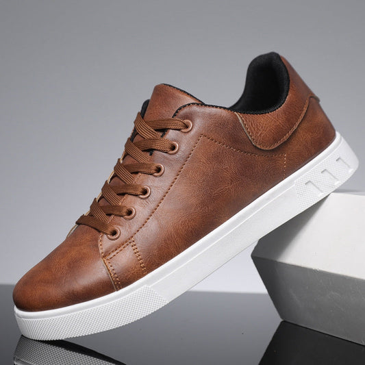 Scarpa da ginnastica marrone in pelle sintetica con suola bianca, design casual, lacci marroni, ideale per moda urbana e comfort quotidiano.
