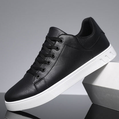 Scarpa da ginnastica nera in pelle sintetica con suola bianca, design moderno, lacci neri, ideale per moda casual e streetwear.