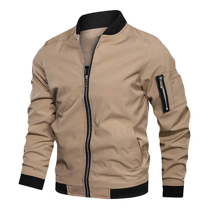 Giacca bomber beige da uomo con zip frontale, tasca con cerniera sulla manica, polsini e colletto neri. Stile casual, moda autunnale.