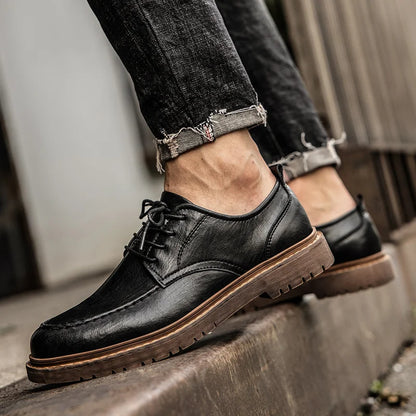Scarpe eleganti in pelle nera da uomo, abbinate a jeans strappati. Calzature classiche con suola robusta, ideali per look casual e formali.