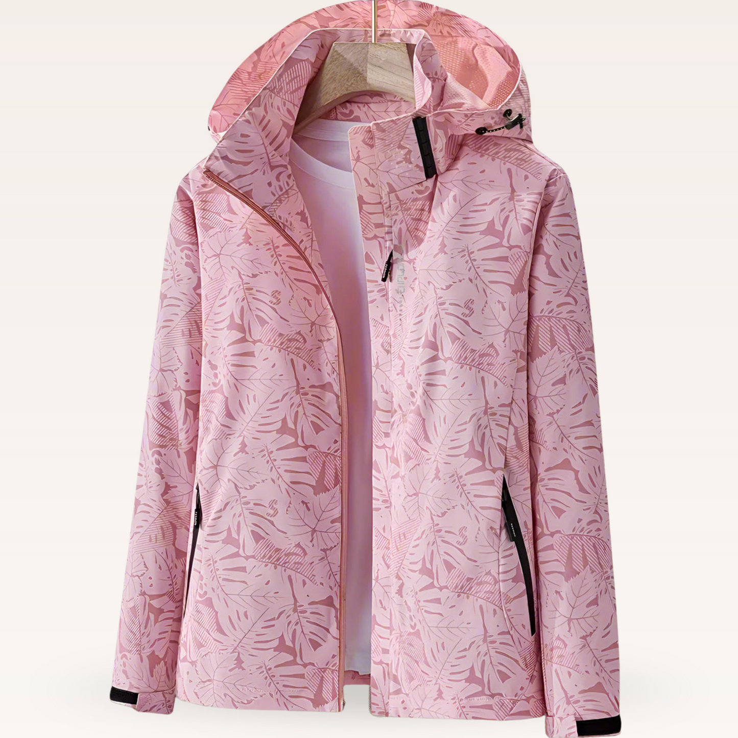 Giacca a vento rosa con motivo floreale, cappuccio regolabile e tasche con zip. Design elegante e funzionale per moda outdoor femminile.