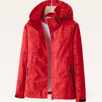 Giacca a vento rossa con cappuccio, motivo foglie, zip frontale, tasche laterali con cerniera. Abbigliamento outdoor impermeabile e traspirante.