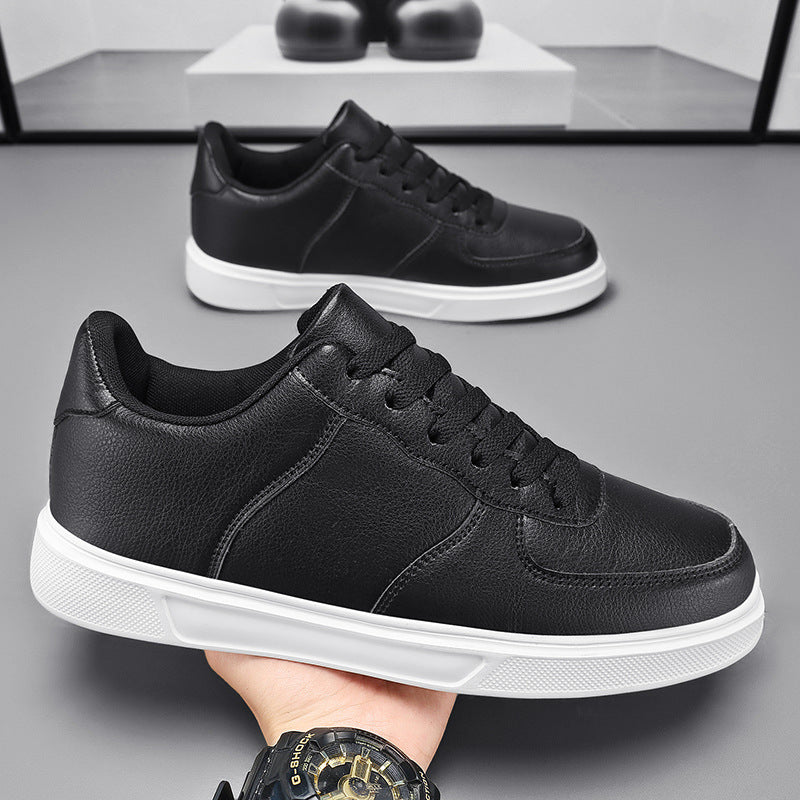 Scarpe da ginnastica nere in pelle con suola bianca, design moderno, su sfondo grigio. Scarpe casual eleganti per uomo, moda urbana.