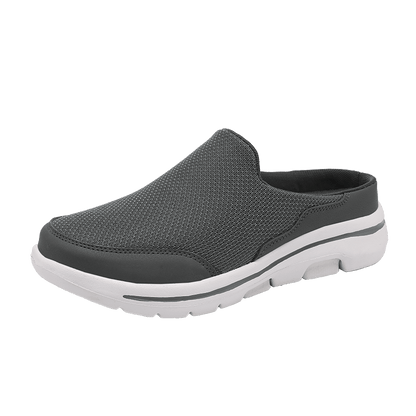 Scarpa slip-on grigia da uomo, design casual con suola bianca in gomma, tessuto traspirante, ideale per passeggiate e tempo libero.