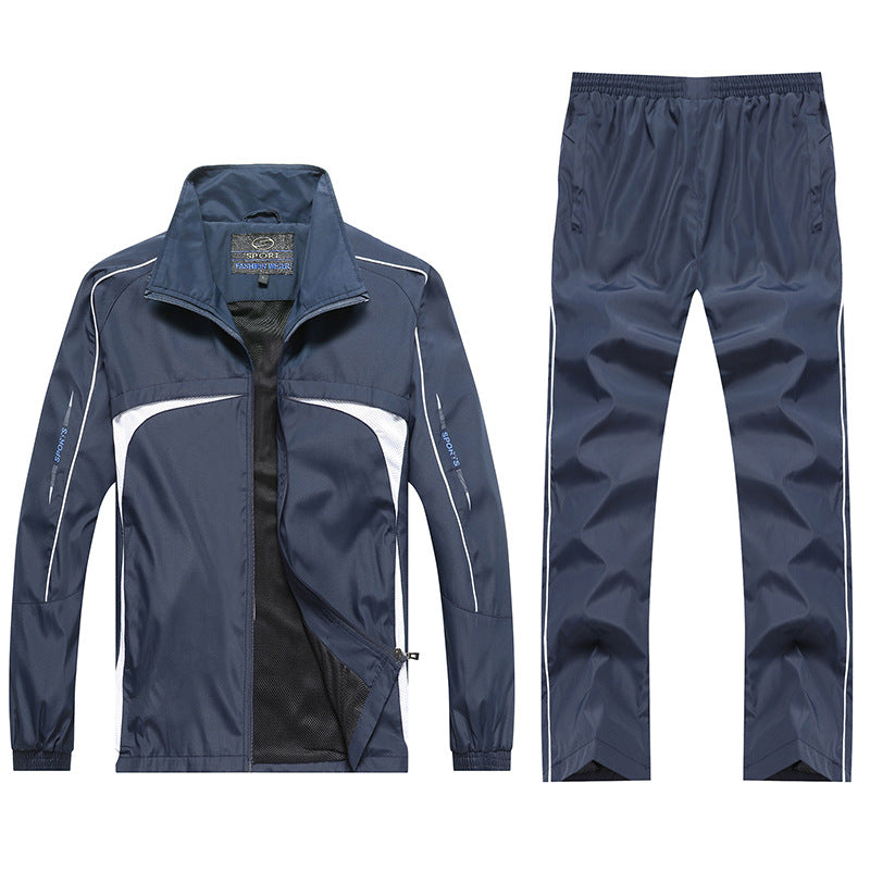 Tuta sportiva blu scuro da uomo, giacca con zip e pantaloni abbinati, design moderno, tessuto traspirante, ideale per jogging e allenamento.