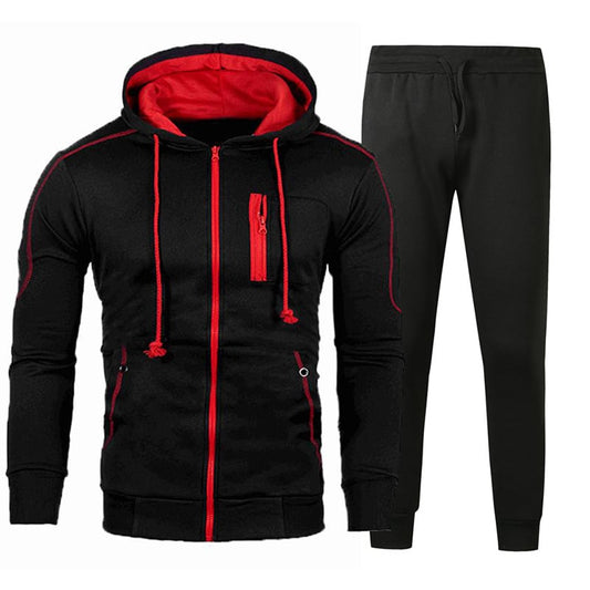 Tuta sportiva uomo nera con cappuccio, dettagli rossi, zip frontale e pantaloni abbinati. Abbigliamento casual, moda fitness, stile urbano.