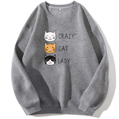 Felpa grigia con stampa di tre gatti sorridenti e scritta "Crazy Cat Lady". Abbigliamento casual, moda felpe donna, stile gatto.